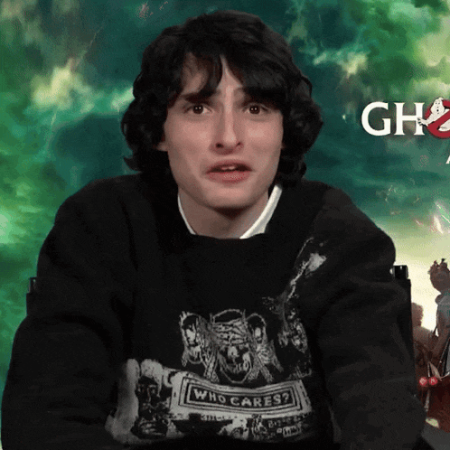 a young man wearing a sweater that says who cares on it