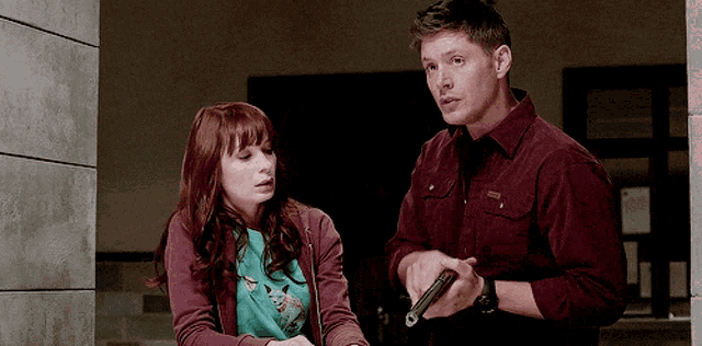 a man is holding a gun next to a woman