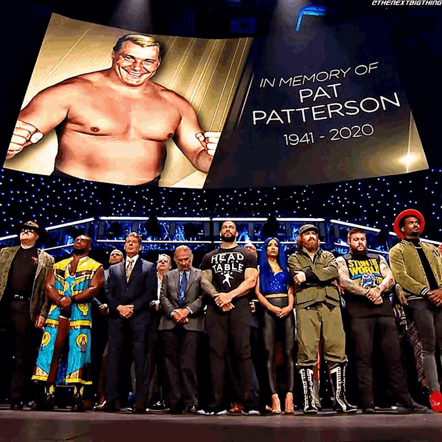 a group of wrestlers standing in front of a screen that says in memory of pat patterson