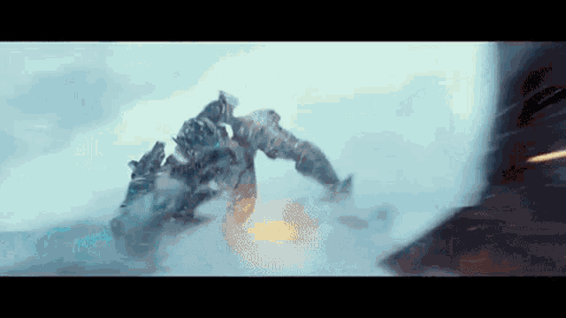 a giant robot is flying through the air in a snowy area .