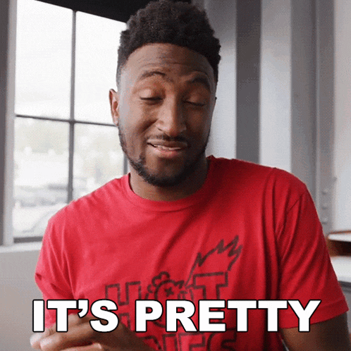 a man wearing a red shirt that says it 's pretty on it