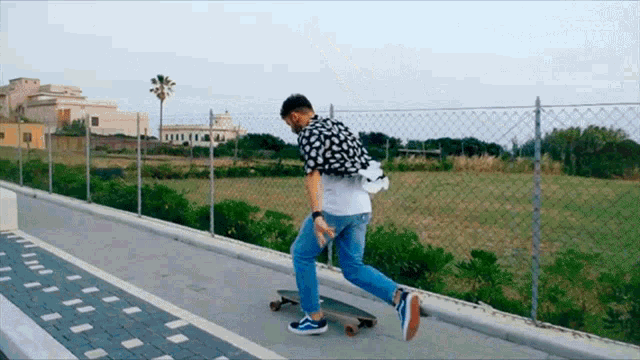 a man is riding a skateboard on a sidewalk with a fence in the background and the word express on the bottom left