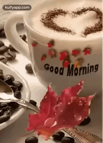 a cup of coffee with a heart on top of it and a spoon in it .