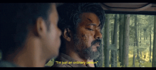 a man with a beard says " i 'm just an ordinary person " while another man looks on
