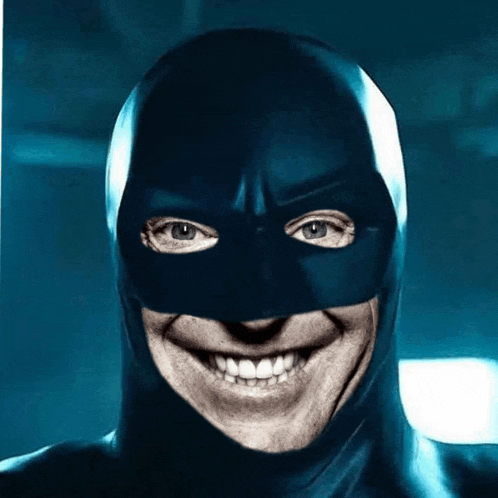 a man wearing a black mask is smiling for the camera