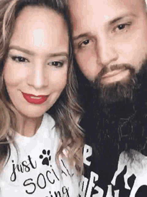 a man and a woman are posing for a picture together .