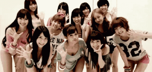 a group of young women are posing for a picture and one of them is wearing a shirt that says 72