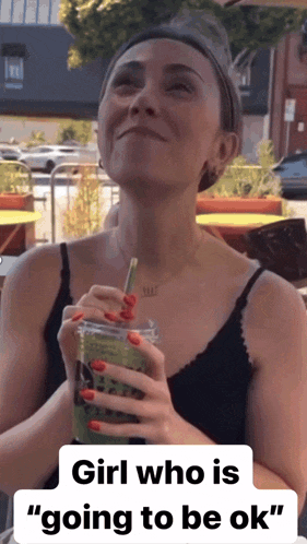 a woman drinking a green drink with a straw and the words " girl who is going to be ok " below her