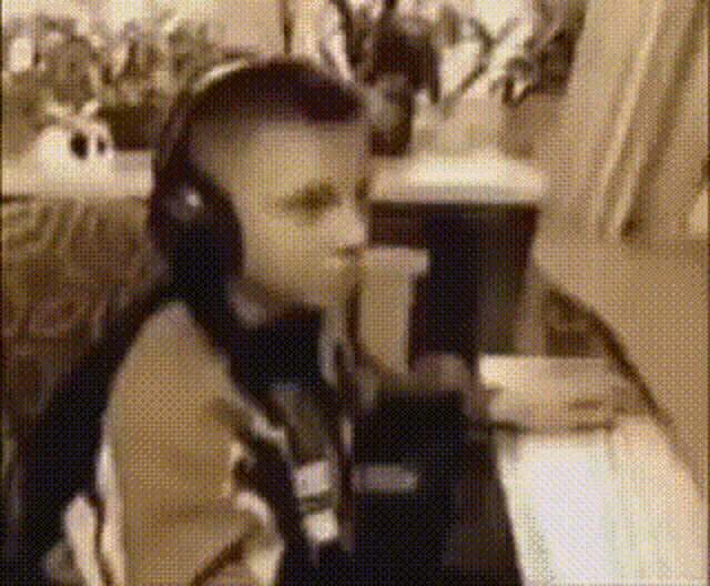 a man wearing headphones is sitting at a desk