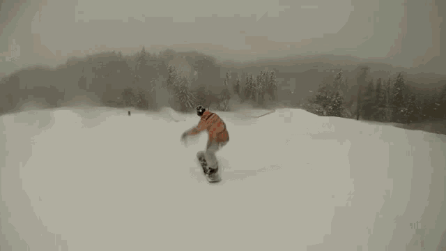a snowboarder is doing a trick on a rail in the snow