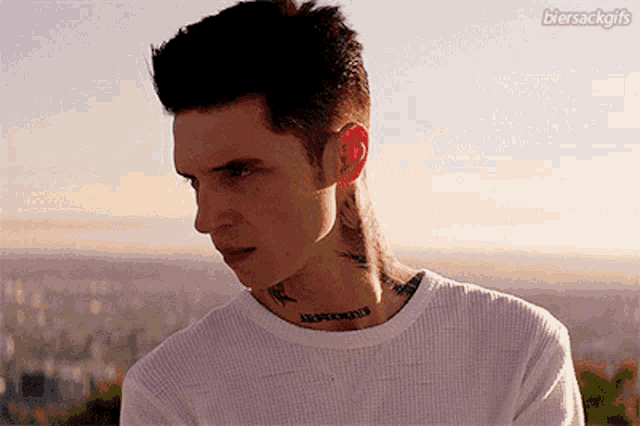 a man with a tattoo on his neck that says jesus