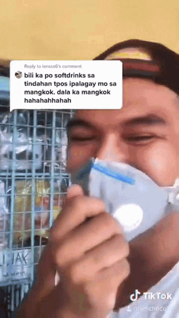 a man wearing a face mask with a reply to lensas6 's comment