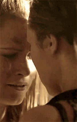 a close up of two women kissing each other .