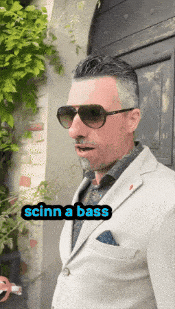 a man in a suit and sunglasses says scinn a bass in a sticker