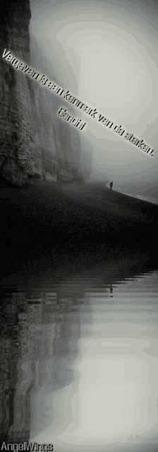 a quote from gandhi is above a cliff and a body of water