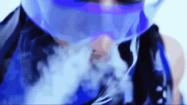 a close up of a person wearing a blue mask smoking a cigarette .