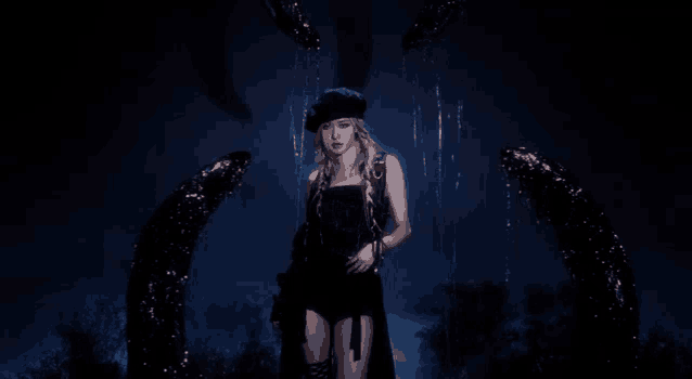 a woman in a black dress and beret is standing in a dark room surrounded by a crescent moon .