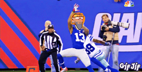 a football player with the number 13 on his jersey is being tackled