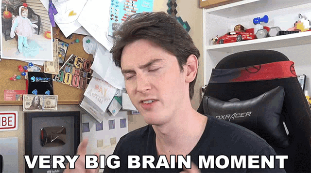 a man says very big brain moment while standing in front of a desk