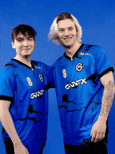 two guys wearing blue shirts with giant written on the front