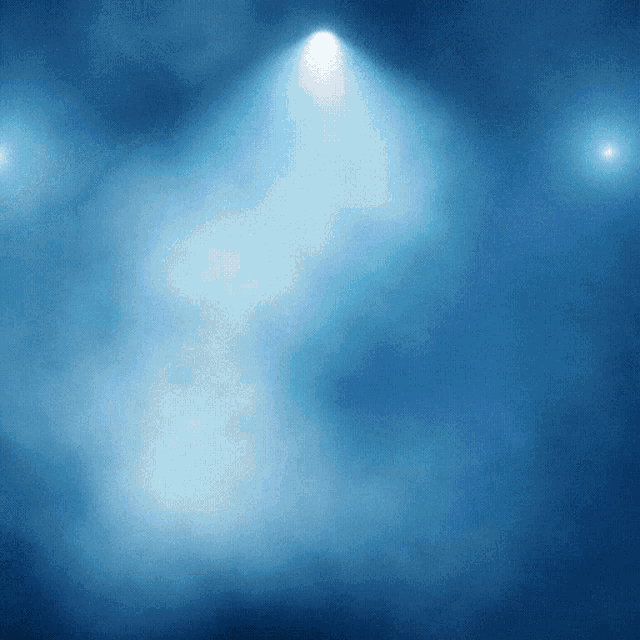 a blue background with a light shining through the fog