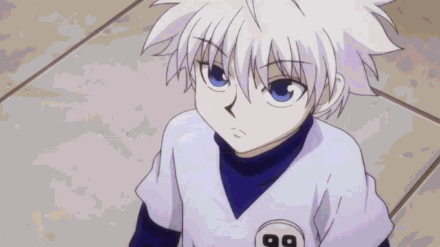 a young boy with white hair and blue eyes is wearing a blue and white shirt with the number 99 on it .