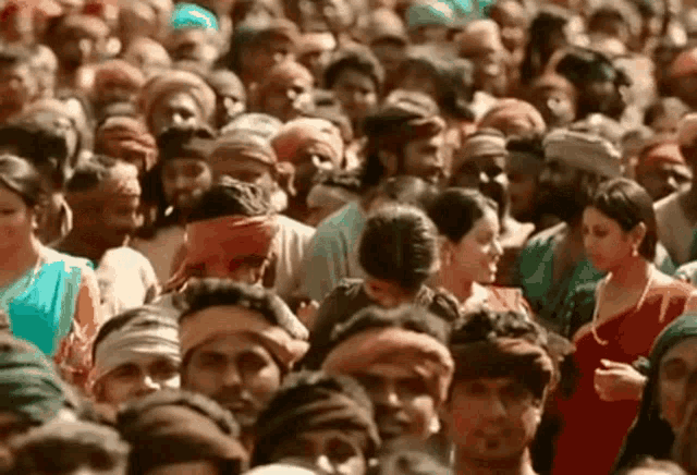 a large crowd of people are gathered together in a stadium .