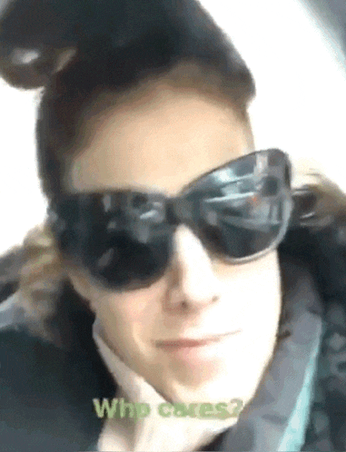a woman wearing sunglasses says " who cares " at the bottom of her face