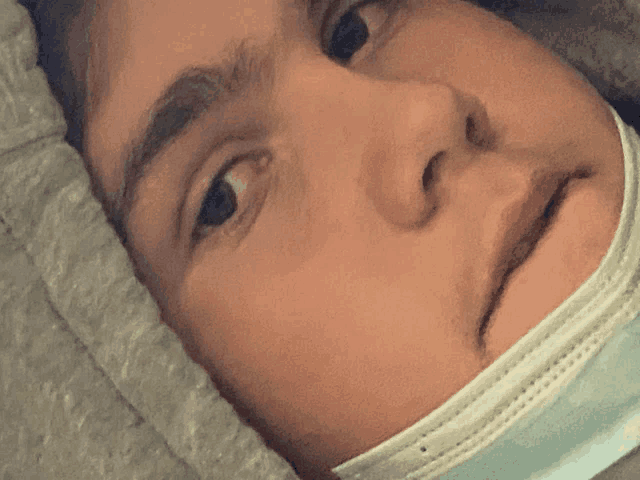 a close up of a person 's face wearing a mask