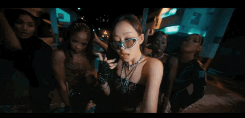 a woman wearing sunglasses and a necklace that says fendi