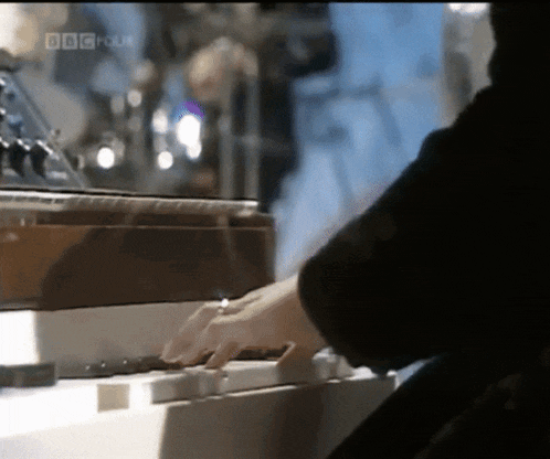 a close up of a person playing a piano with the words bbc focus visible