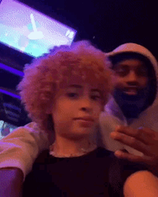 a man with a beard is taking a selfie with a girl with curly hair