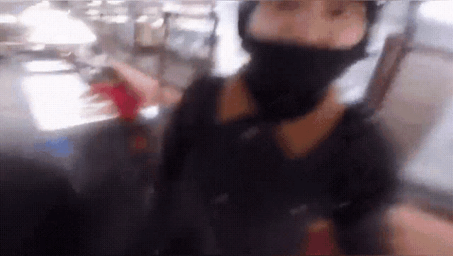 a blurry photo of a person wearing a black mask