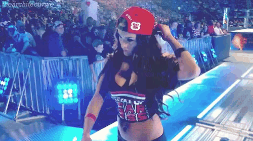 a woman wearing a red hat and a shirt that says wwe