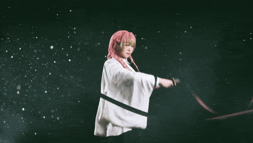 a woman in a pink wig holds a sword in front of chinese writing
