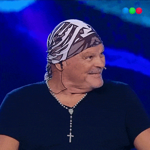 a man wearing a bandana and a rosary necklace with a cross on it