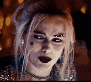 harley quinn from harley quinn 's birds of prey is making a funny face with her mouth open .