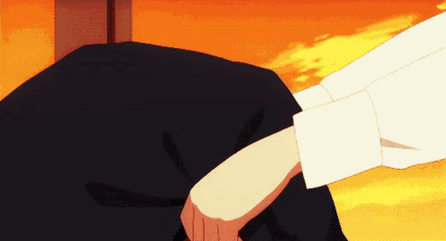 a close up of a person 's knee with a sunset in the background
