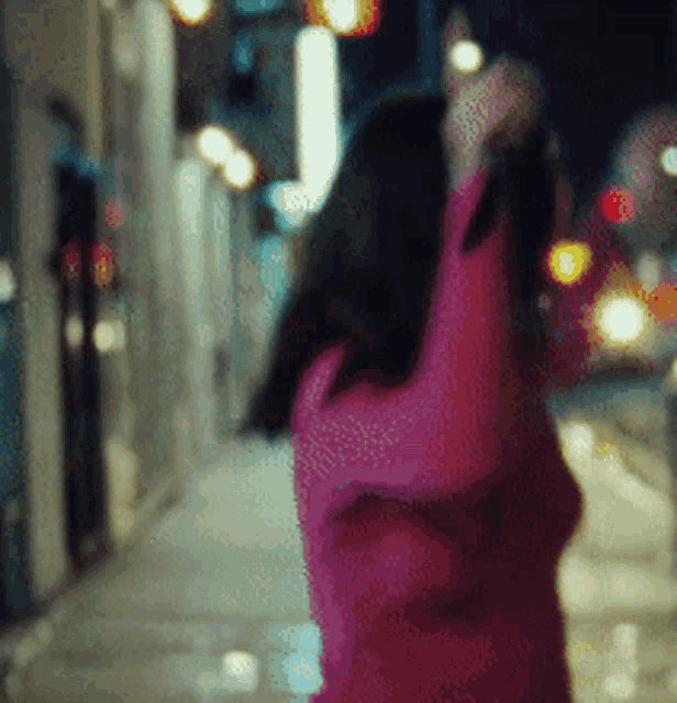 a blurry picture of a woman in a pink sweater