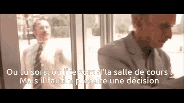 a man in a suit and tie talks to another man