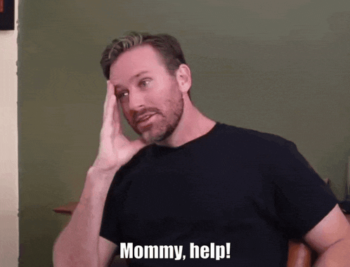 a man with a beard holds his hand to his head and says mommy help