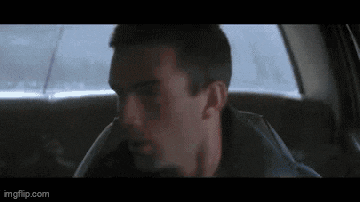 a close up of a man sitting in the back seat of a car .