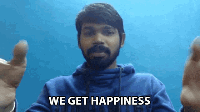 a man with a beard wearing a blue sweatshirt that says we get happiness