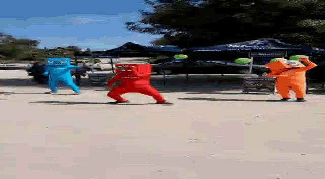 a group of people in colorful costumes are dancing in front of a blue tent that says torah