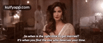 a woman in a white dress is standing in a room with a quote .