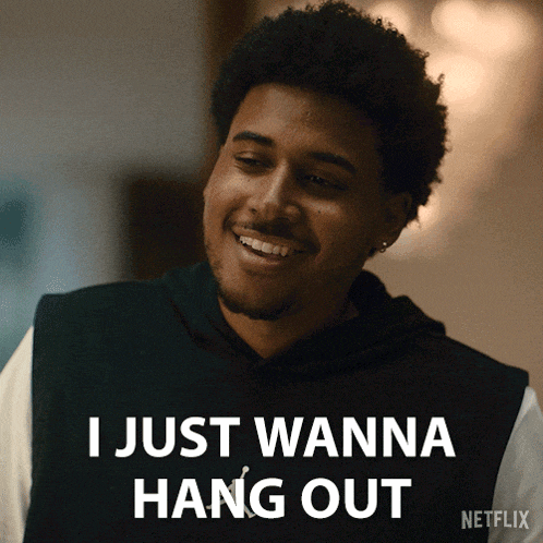 a man is smiling with the words i just wanna hang out above him