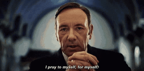 a man in a suit and tie is praying to himself for myself .