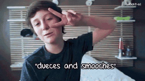 a boy making a peace sign with the words " dueces and smooches " written on the bottom