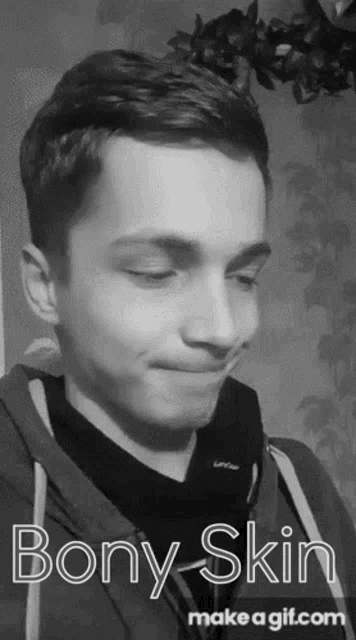 a black and white photo of a young man making a funny face with the words bony skin on the bottom .