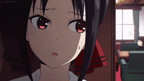 a close up of a girl 's face with a red bow on her hair